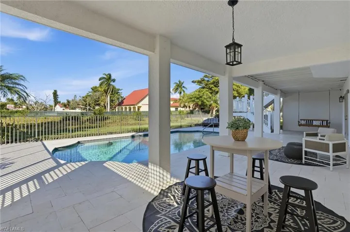 View of pool featuring a patio area - Virtually Edited
