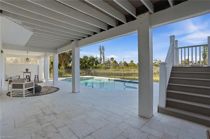 View of pool featuring stairs, a patio area, and a fenced backyard - Virtually Edited