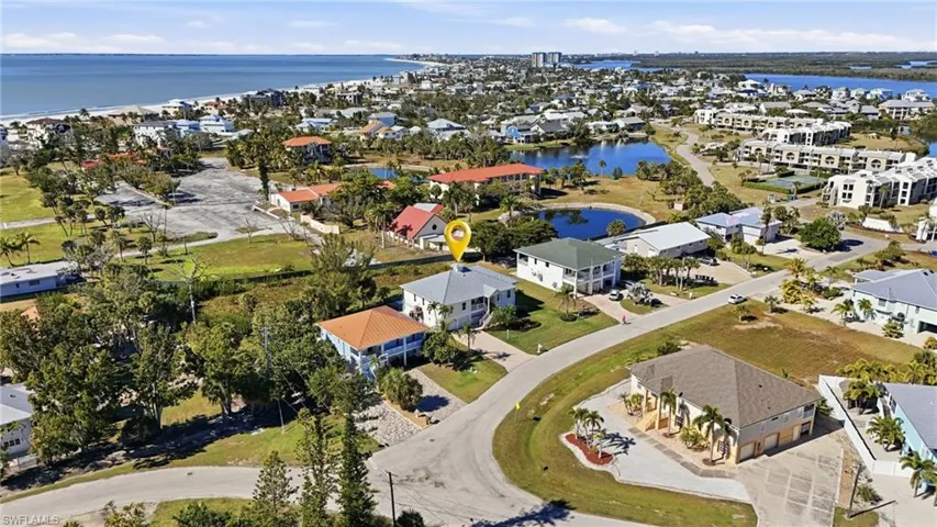 Aerial perspective of suburban area with a large body of water - Virtually Edited