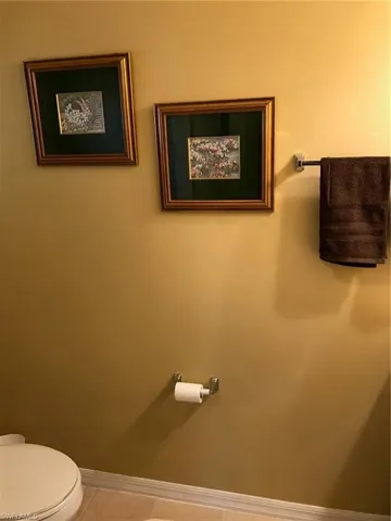 Bathroom featuring toilet and tile patterned flooring
