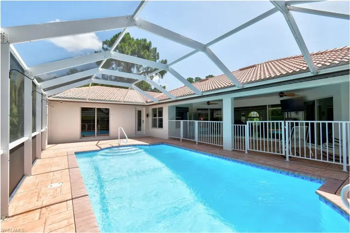 View of pool featuring a patio area, ceiling fan, and a lanai