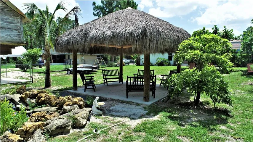 View of property's community with a yard and a patio