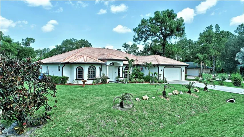 View of front of home featuring a garage and a front lawn