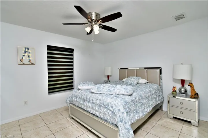 Tiled bedroom with ceiling fan