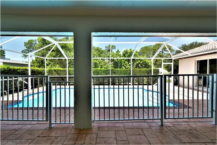 View of swimming pool with a lanai and a patio