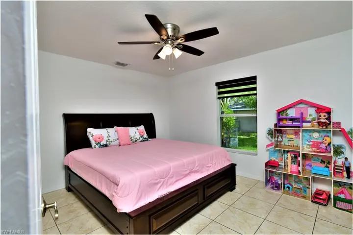 Bedroom featuring ceiling fan and light tile patterned flooring