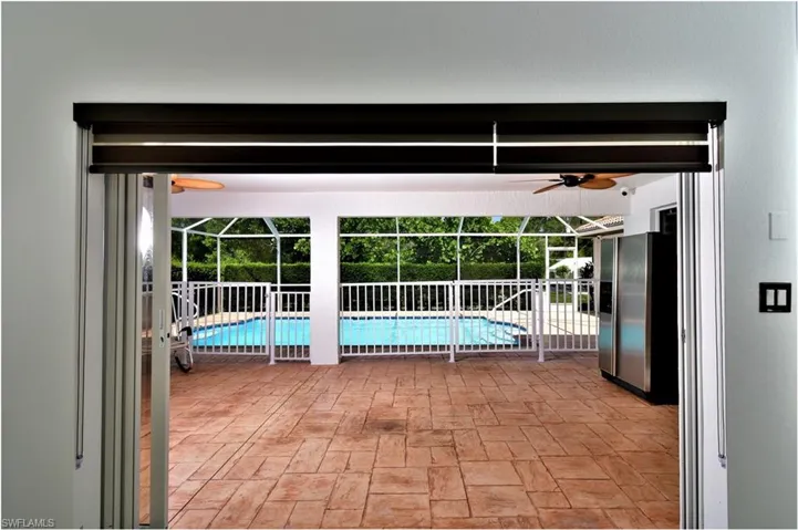 View of swimming pool featuring ceiling fan