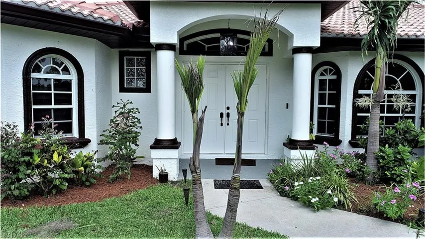 View of exterior entry featuring covered porch
