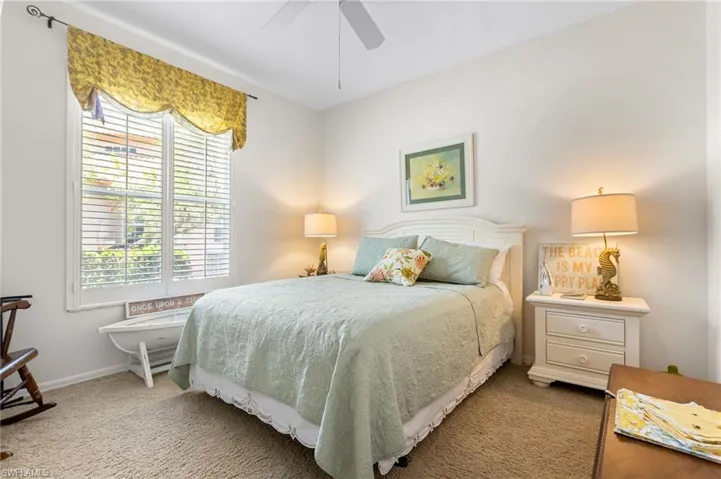 Bedroom with carpet floors, baseboards, and a ceiling fan