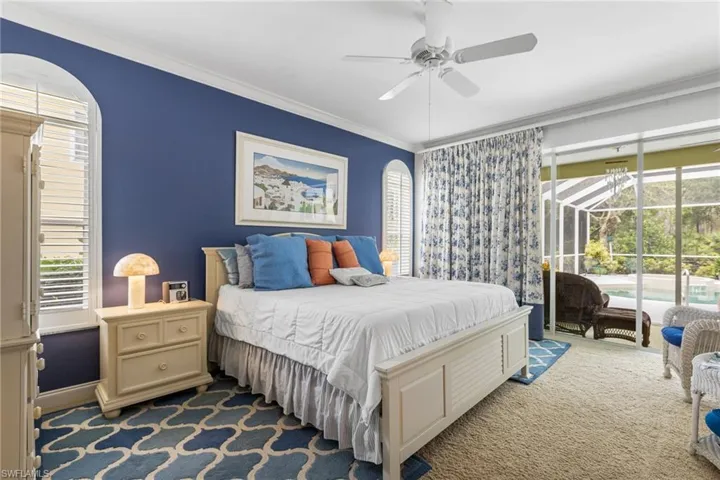 Bedroom with multiple windows, carpet floors, crown molding, and access to outside