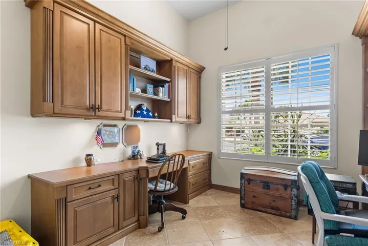 Office area featuring baseboards and built in study area