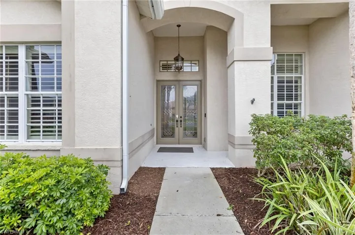 View of exterior entry with french doors and stucco siding