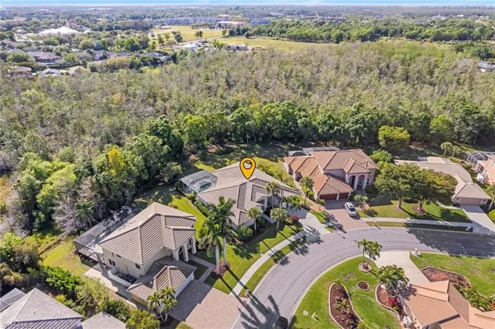 Birds eye view of property featuring a wooded view and a residential view