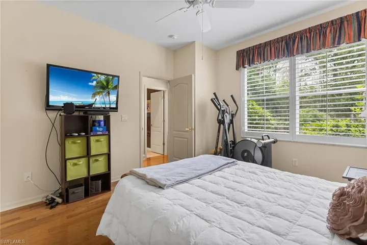 Bedroom with baseboards, a ceiling fan, and wood finished floors