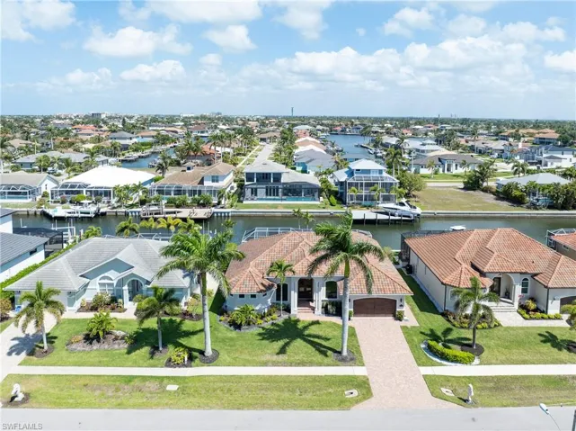 Birds eye view of property with a residential view and a water view