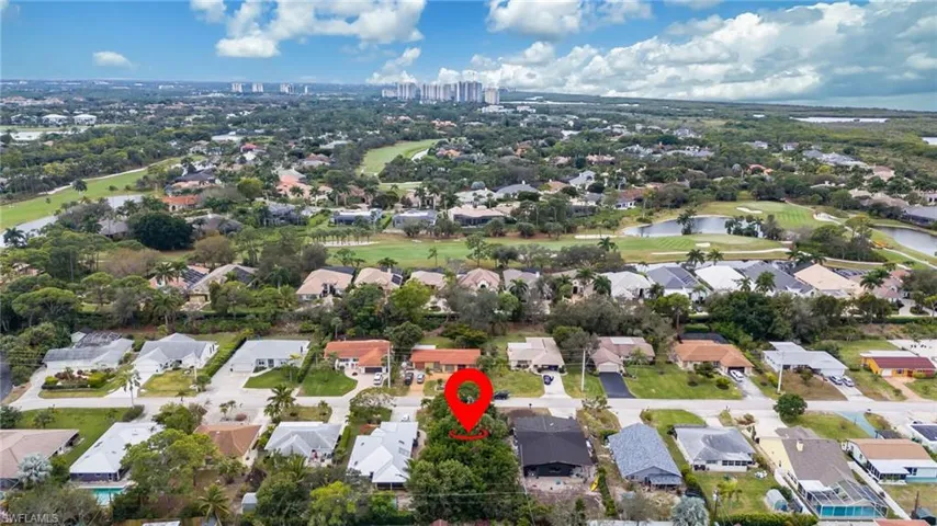 View of property location featuring a local golf course and nearby suburban area