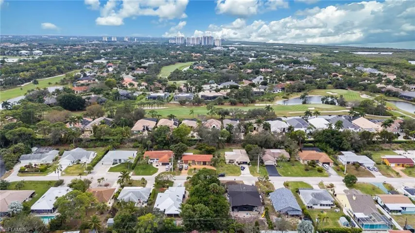 View of property location with a local golf course and nearby suburban area