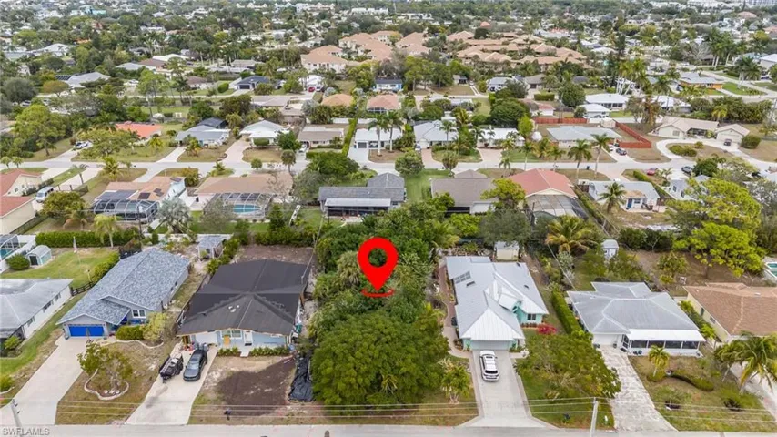 Aerial view of property and surrounding area with nearby suburban area
