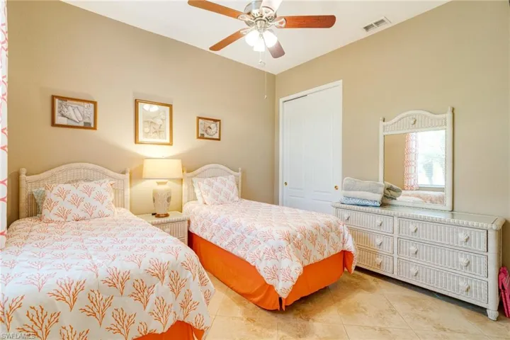Tiled bedroom featuring a ceiling fan, a closet, and visible vents