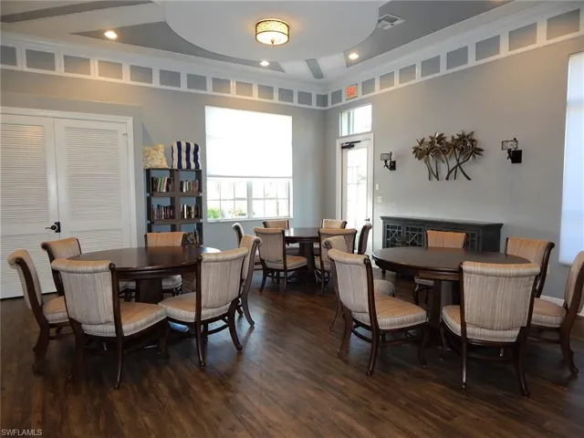 Dining room featuring ornamental molding, dark wood-type flooring, visible vents, and recessed lighting