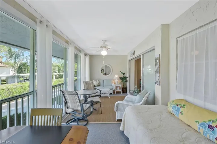 Large enclosed lanai with sliding glass doors to let in the gulf breezes and views of the Park Shore neighborhood.