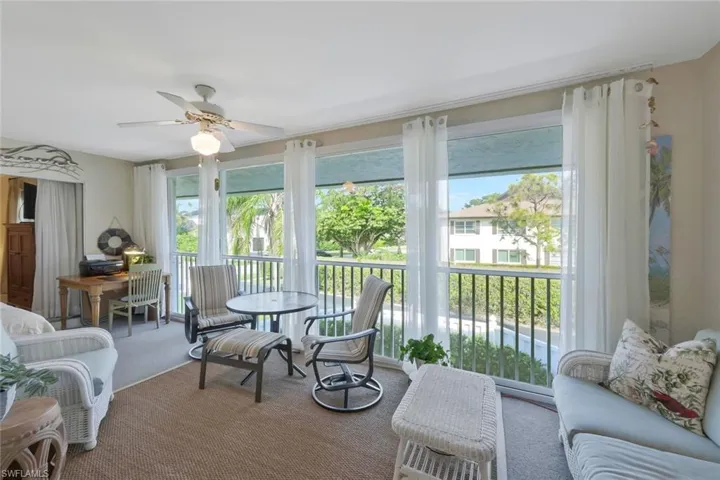Large enclosed lanai with sliding glass doors to let in the gulf breezes and views of the Park Shore neighborhood.