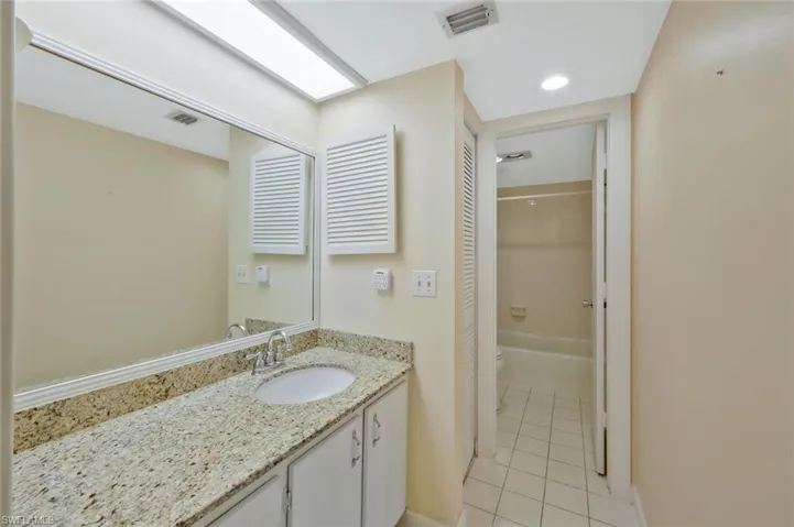 Master bathroom with vanity, shower/tub combo and W/C.