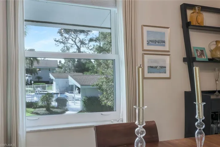 Dining room with view of the community clubhouse and pool.
