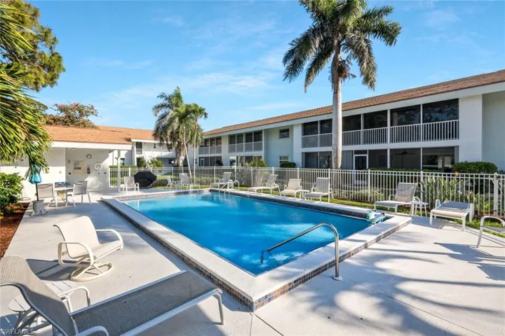 Community pool with clubhouse and grill area.