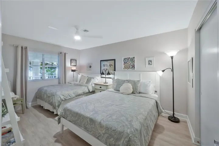 Guest bedroom with luxury vinyl flooring and large closet.