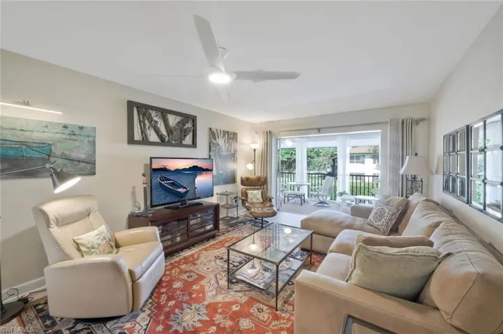 Family room with ceiling fan, luxury vinyl floors and sliding doors to the lanai.