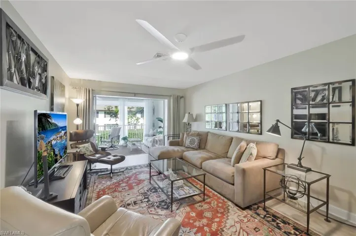 Family room with ceiling fan, luxury vinyl floors and sliding doors to the lanai.