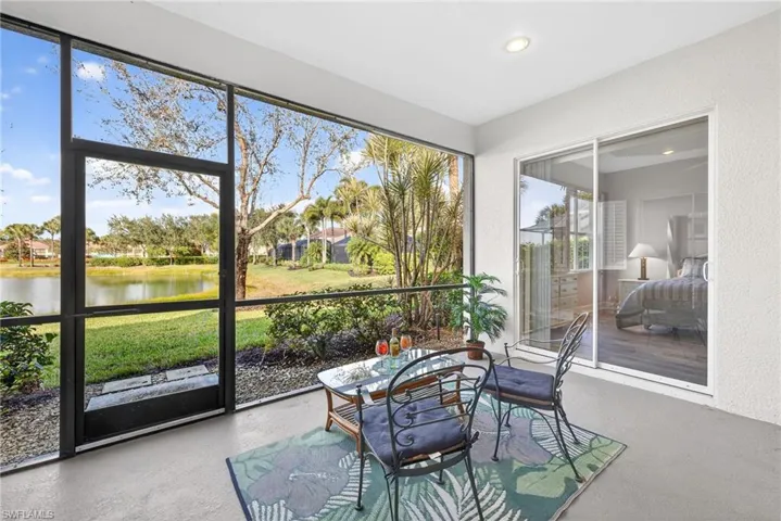 Sunroom featuring a water view
