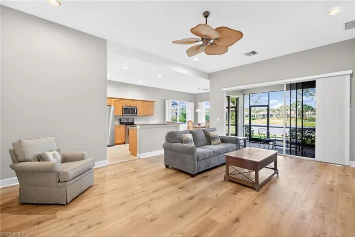 Living area featuring recessed lighting, light wood-style flooring, and a ceiling fan