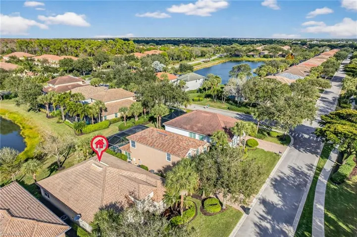 Aerial view of residential area featuring a nearby body of water
