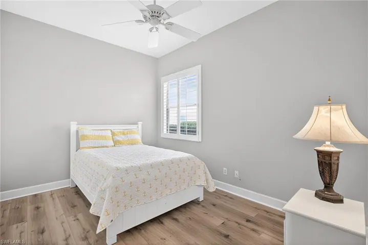 Bedroom featuring wood finished floors and a ceiling fan