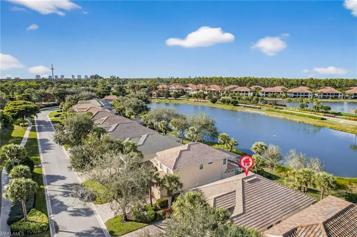 Aerial perspective of suburban area featuring a nearby body of water