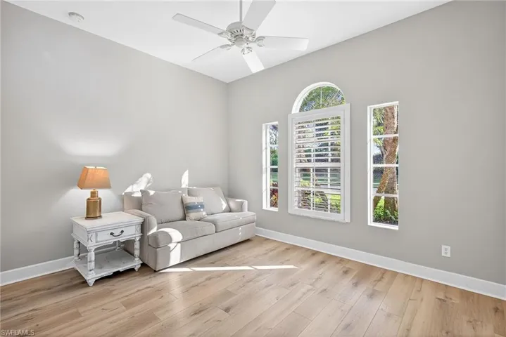 Sitting room featuring light wood-style flooring and ceiling fan