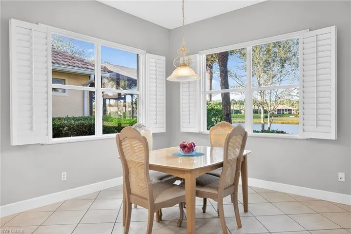 Dining room featuring a water view and light tile patterned floors