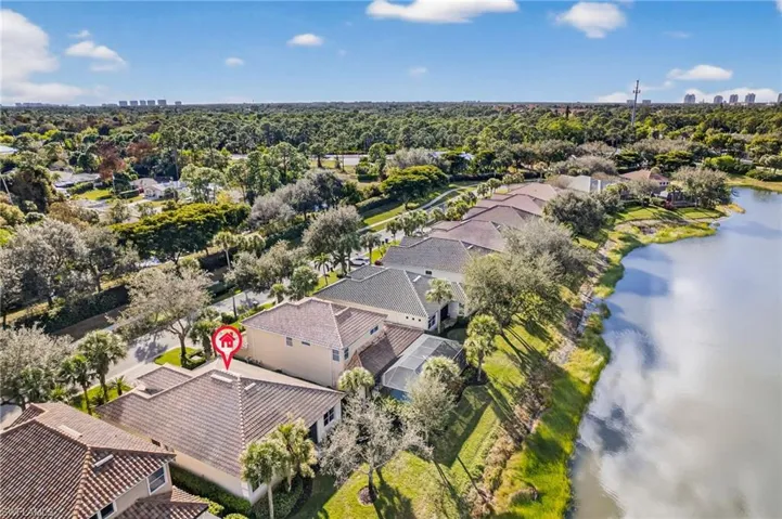 Aerial view of residential area featuring a nearby body of water