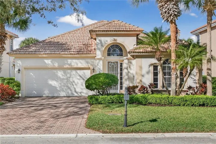 Home featuring stucco siding, decorative driveway, an attached garage, a front yard, and a tile roof