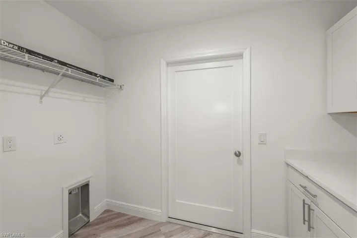 The laundry room has extra cabinets to act as a pantry on the right