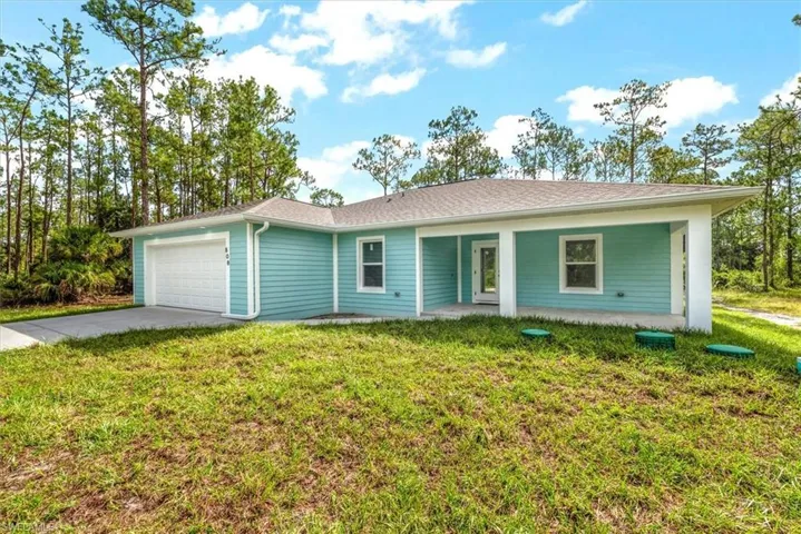 The front of the home has a wood plank style stucco design adding more character than the standard home finish.