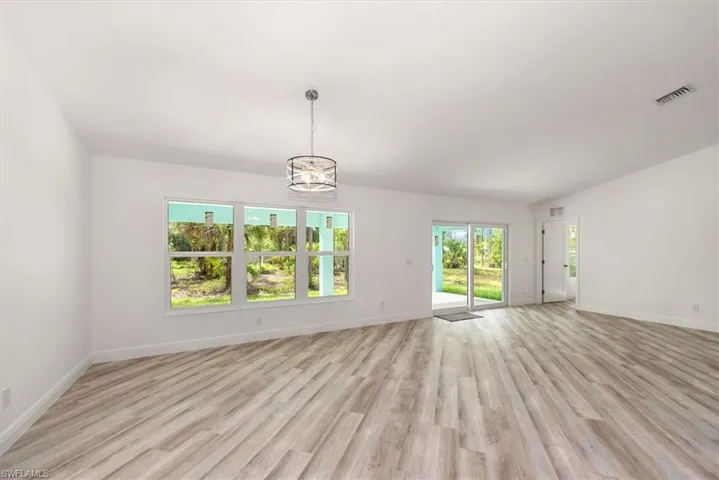 Dining area with a triple window view of the back yard