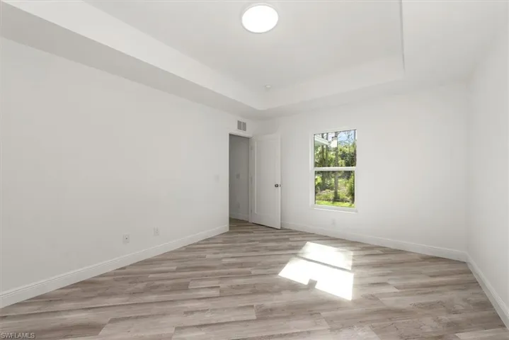 Master bedroom with a tray ceiling