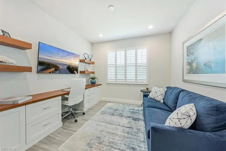 Office area featuring light hardwood / wood-style flooring and built in desk