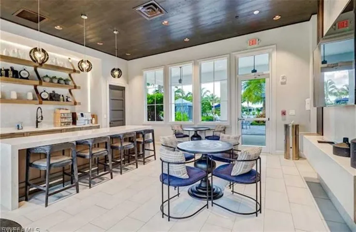 Tiled dining area featuring sink and wooden ceiling