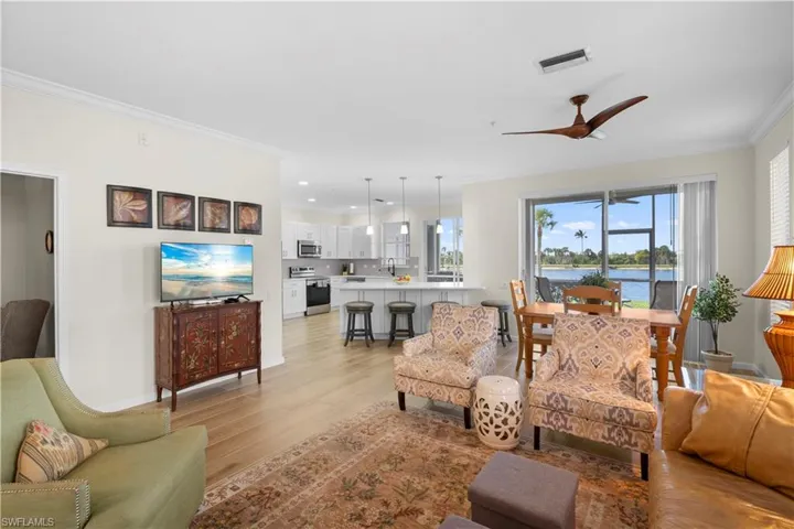 Living area with ornamental molding, light wood-style floors, ceiling fan, and recessed lighting