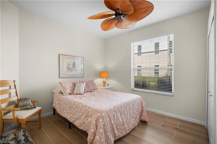 Bedroom with wood finish floors, a ceiling fan, and a closet