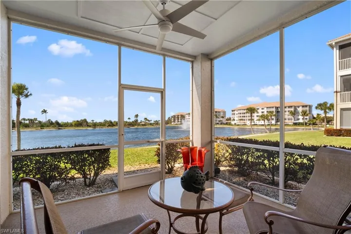 Sunroom featuring a water view and expansive windows